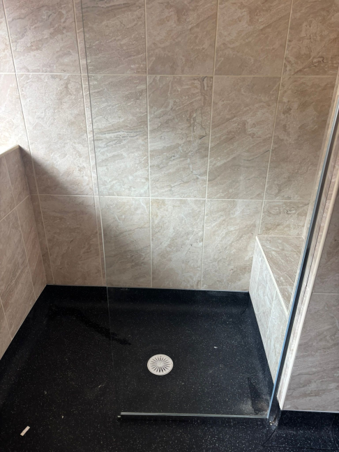 Marble-tiled shower with linear drain