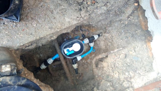 Underground water meter and stopcock installation in excavated trench