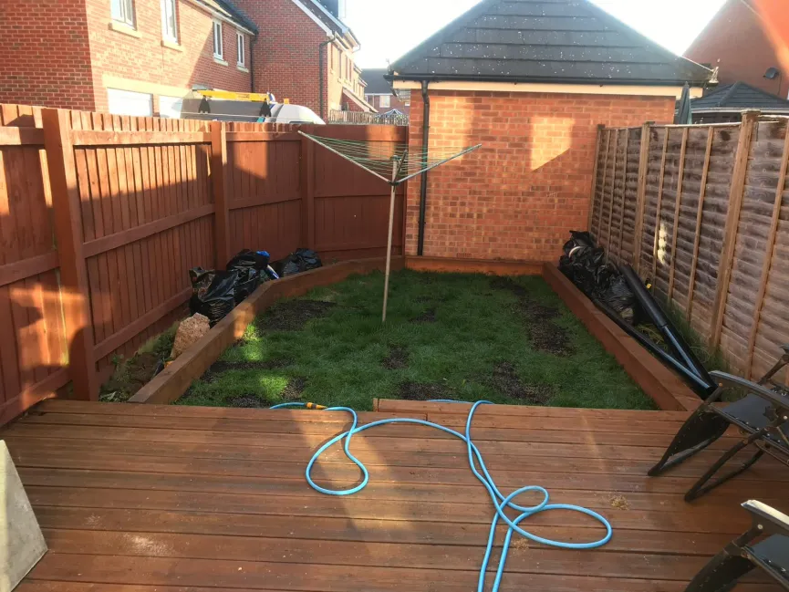 Freshly laid garden decking with raised beds