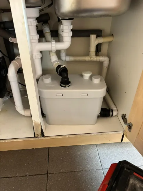 Saniflo macerator pump installed under kitchen sink